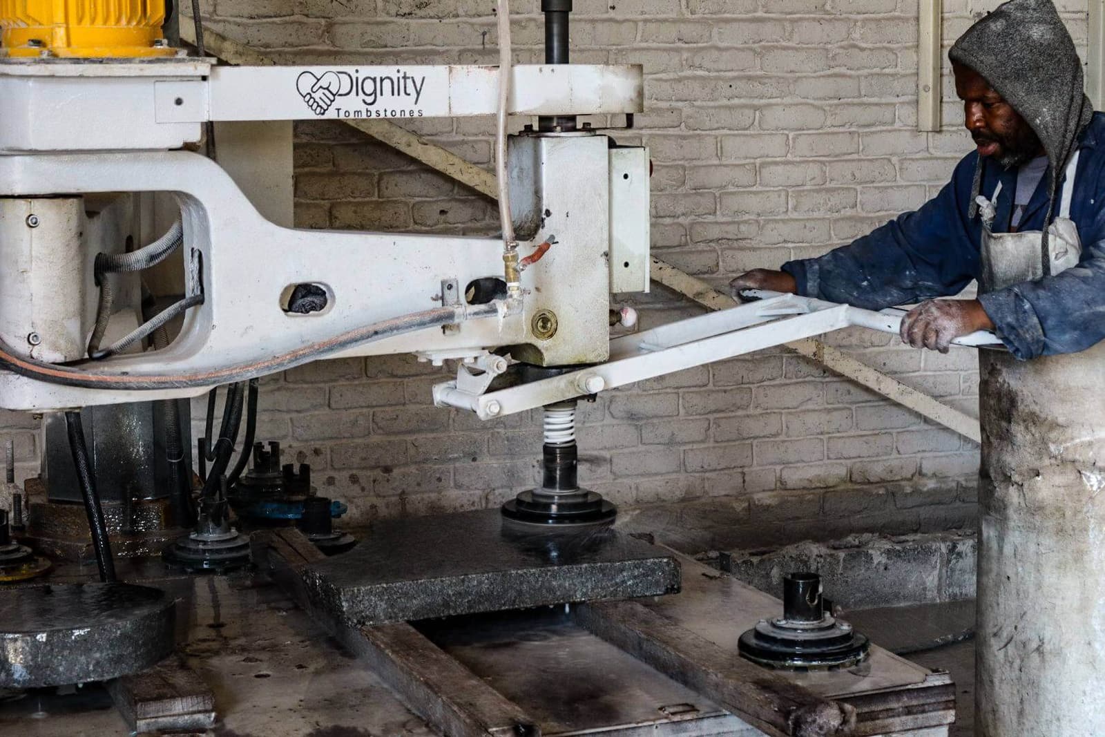 A Dignity craftsman polishing granite in the factory