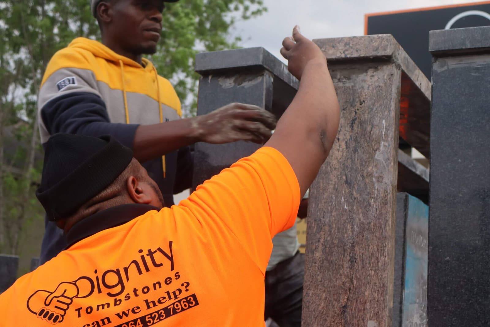 The Dignity team setting a tombstone at the grave