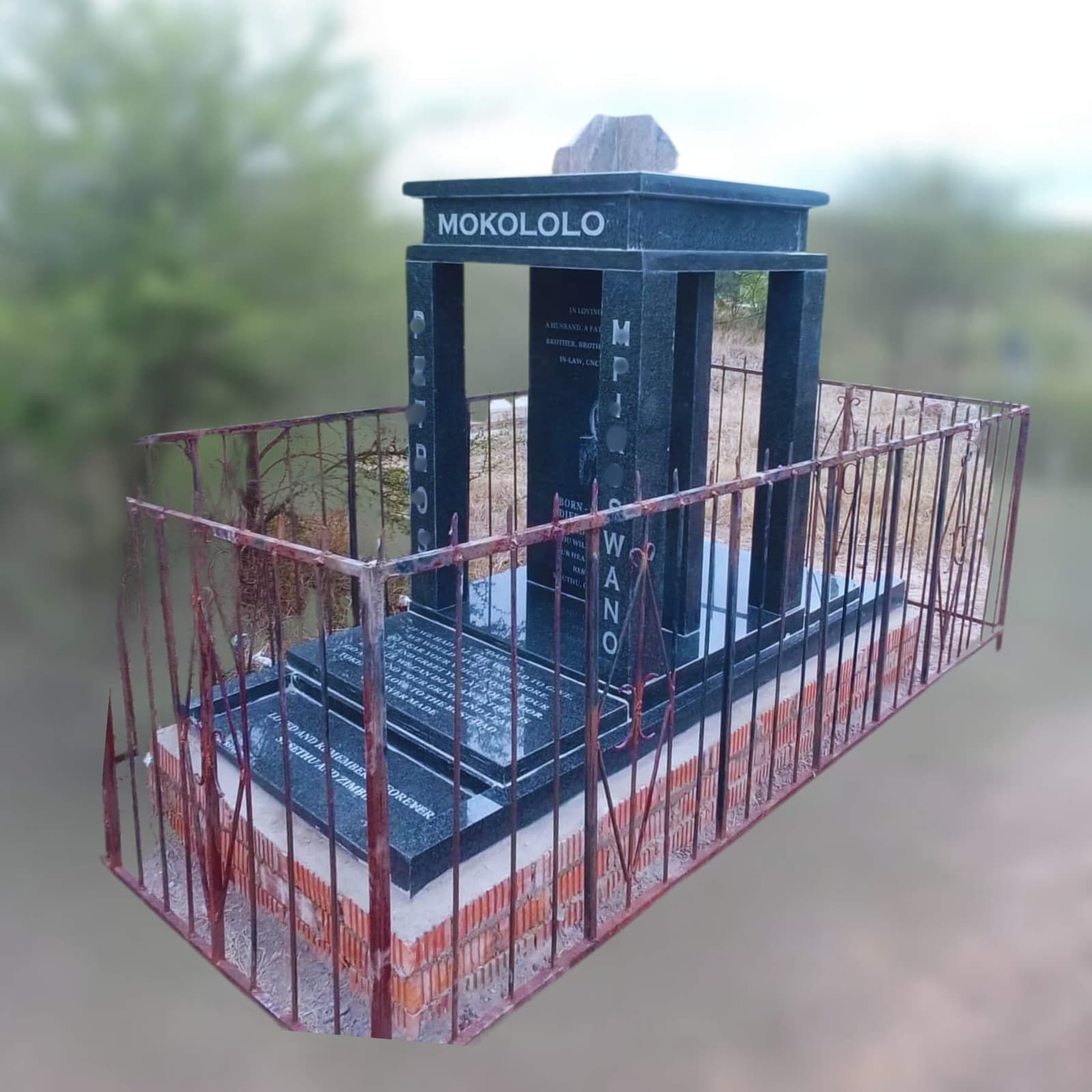 DEX 14 tombstone for the Mokololo family, with a railing
