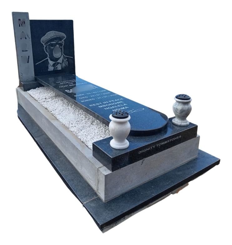 MAX I tombstone: black granite headstone with a portrait panel, two vases and a white-chip bed on a stepped base