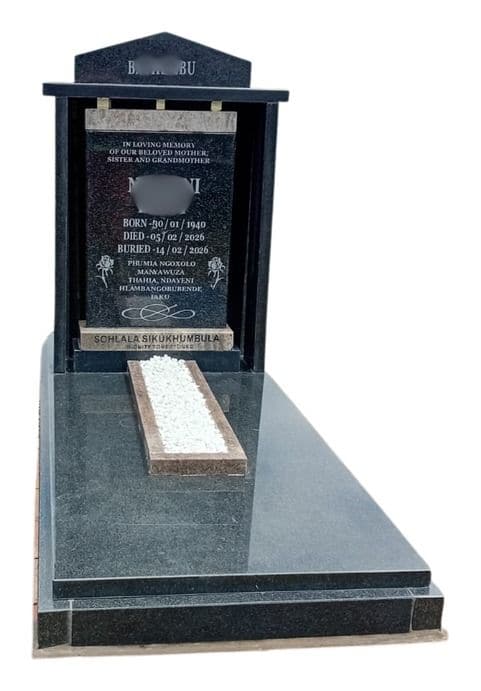 MAX R tombstone: gabled headstone between two pillars, with a white-chip bed on a polished slab